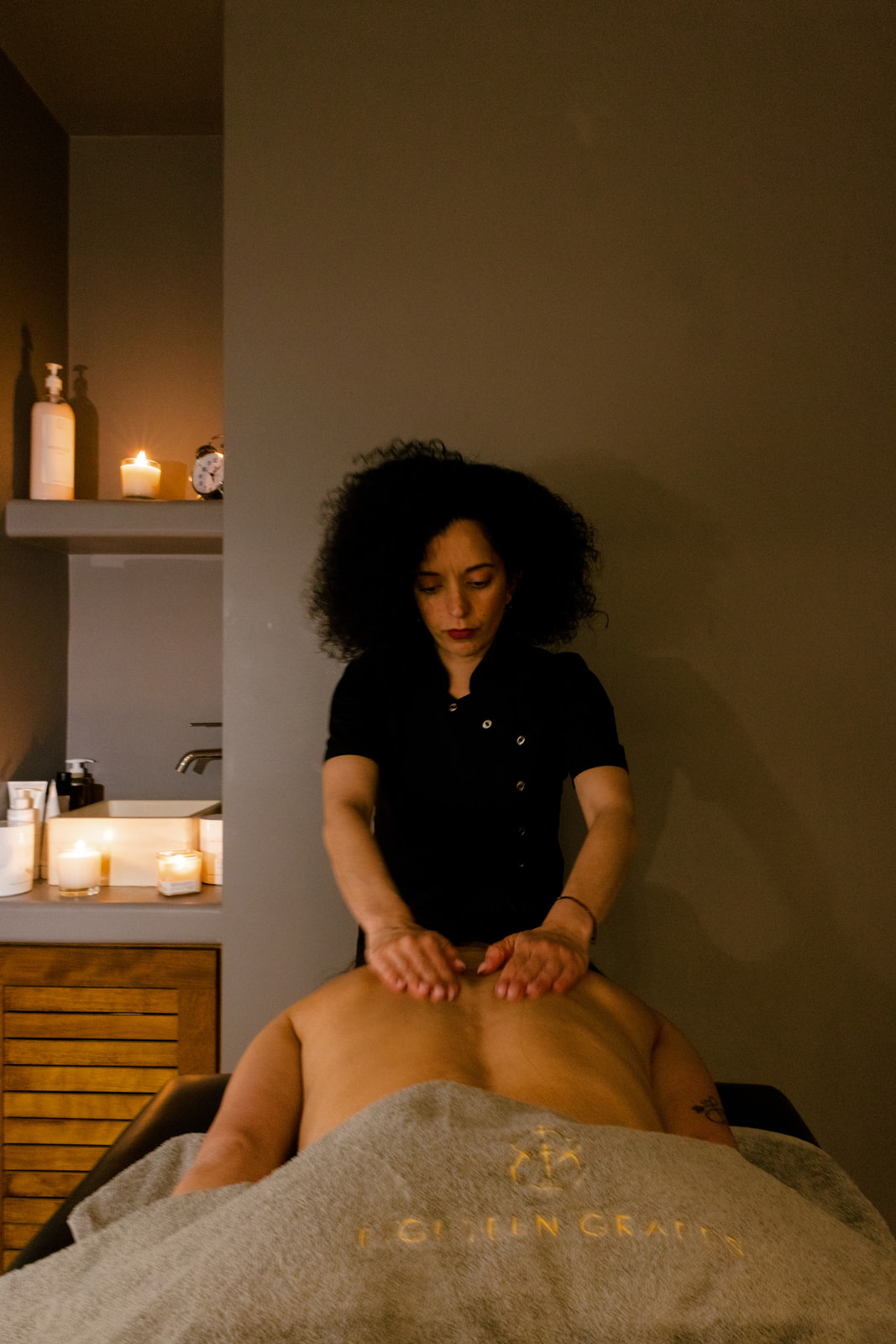 Therapist preparing a spa Naxos treatment with candles
